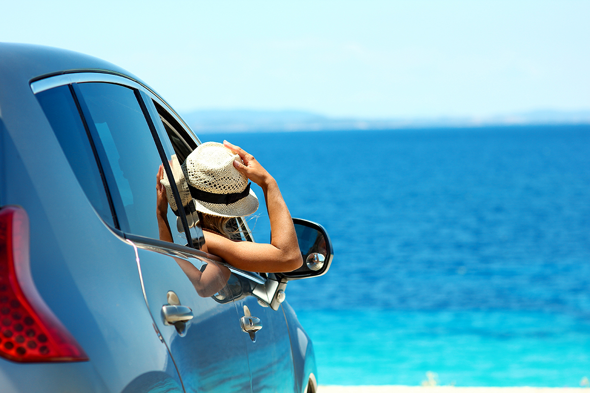 a  driver girl in car at sea in summer